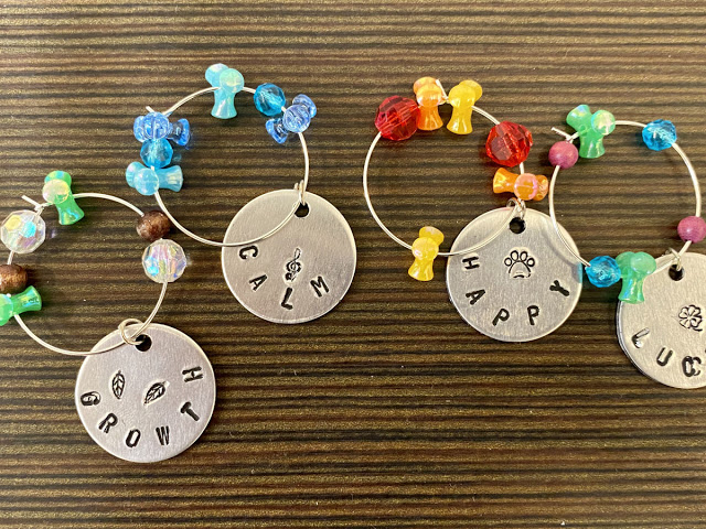 DIY Wine Glass Charms: Women's Craft Night Idea for Make & Take Crafts. Looking for a fun make and take craft project for your women's craft night? These DIY wine glass charms are a fun adult craft for every skill level! An easy and fun adult craft night idea for women of all skill levels, this project is perfect for a wine and art night with friends. Pair your event with your favorite bottle of wine and a good time is guaranteed! Learn how to use metal stamping to make wine glass charms. DIY Wine Glass Charms: Women's Craft Night Idea for Make & Take Crafts. Looking for a fun make and take craft project for your women's craft night? These DIY wine glass charms are a fun adult craft for every skill level! An easy and fun adult craft night idea for women of all skill levels, this project is perfect for a wine and art night with friends. Pair your event with your favorite bottle of wine and a good time is guaranteed! Learn how to use metal stamping to make wine glass charms.