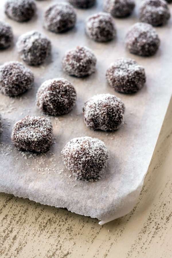No bake bourbon balls recipe rolled in coconut for the ultimate no bake Christmas cookies for homemade holiday food gifts. These easy bourbon balls not only taste delicious, they’re also gluten free. So everyone can enjoy the delectable taste of chocolate and bourbon this holiday season. A delightful Christmas dessert recipe, these no bake bourbon balls can also be made with rum or customized with your favorite ingredients whether it be coconut or dried raspberries for a flavorful holiday treat!