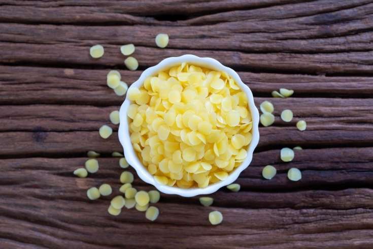 natural beeswax pastilles in white dish