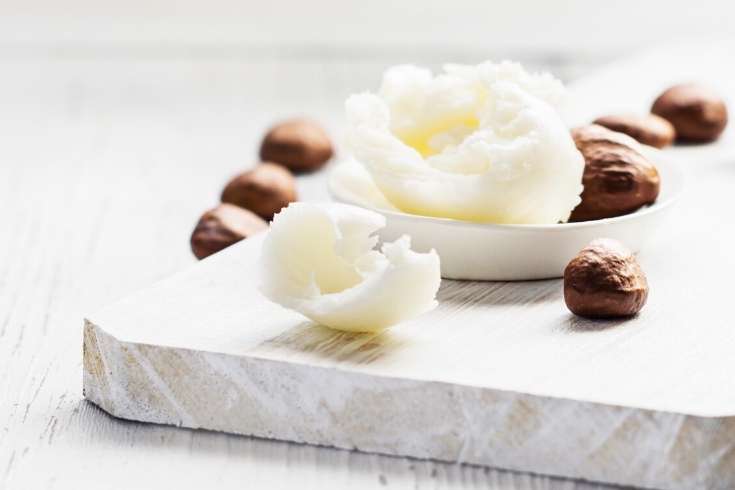 shea butter and shea nuts on cutting board