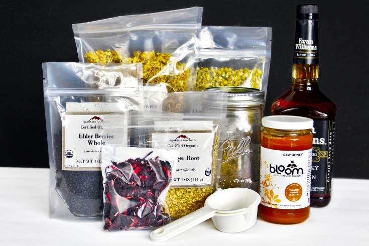 Elderberry Immunity Elixir Recipe with Herbs: A Cold and Flu Elixir. Learn how to make an elderberry tincture recipe as a natural cold and flu elixir for cold and flu relief and immune support. Discover the benefits of an elderberry tincture and how it supports immune health. Plus herbs you can use in your tincture to create a natural cold remedy to boost immunity. This natural immunity elixir recipe is an alcohol based tincture made with elderberries and herbs for immune support.