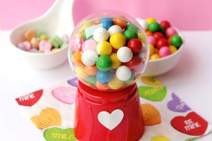 DIY Valentines for Kids: How to Make Mini Gumball Machines with free printable valentines for kids. Plus more Valentine's day crafts for the perfect DIY Valentine's day gifts for kids. This DIY mini gumball machine is the perfect Valentine for your little mini me's! Kids absolutely love these replica gumball machines filled with multi-colored gumballs or Valentine's day candy. Plus they're simple and easy to make. Keep reading to learn how to make this easy Valentine's day craft for kids.