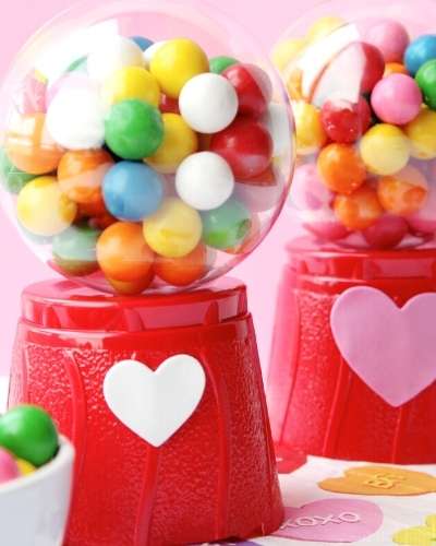 These DIY mini gumball machines make adorable DIY valentines for kids. This easy Valentine's day craft is the perfect way to show your mini me how much you love them. Or make extras of these for classroom valentines when you download and print the free printable valentines included with this project.