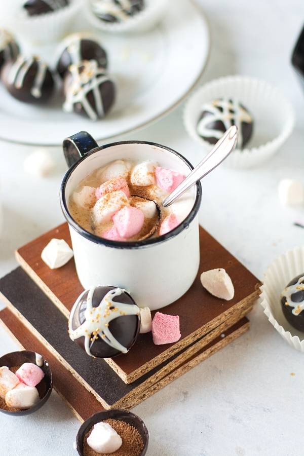 How to make a hot chocolate bomb recipe with miniature marshmallows. Hot cocoa bombs are similar to the hot chocolate mix you use to make a cup of hot cocoa. The difference is, rather than the mix being in a canister, it's stored inside a shell of chocolate. This chocolate shell holds the perfect amount of hot chocolate mix to make a cup of hot chocolate. They can also hold marshmallows inside for the perfect warm winter drink. The chocolate shell melts when you add warm milk or hot water.