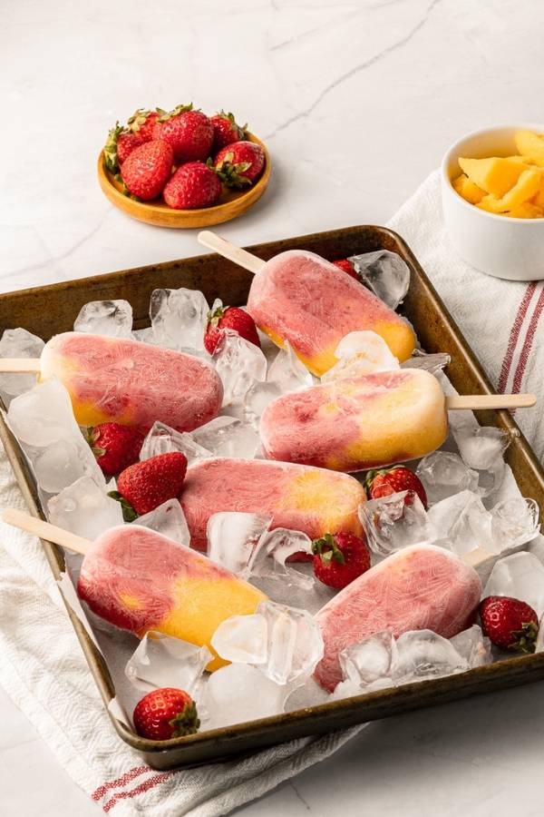 mango strawberry popsicles with fruit and yogurt
