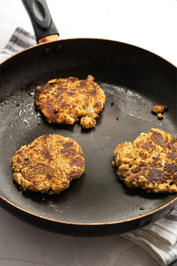 pan fry veggie fritters in olive oil on hot skillet