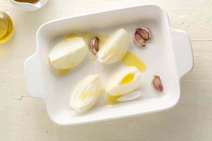 roasting onion and garlic cloves to make sweet roasted pumpkin soup for fall