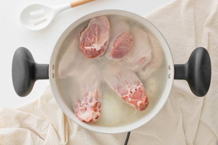 add pork meat and bones pot to make mexican pozole rojo