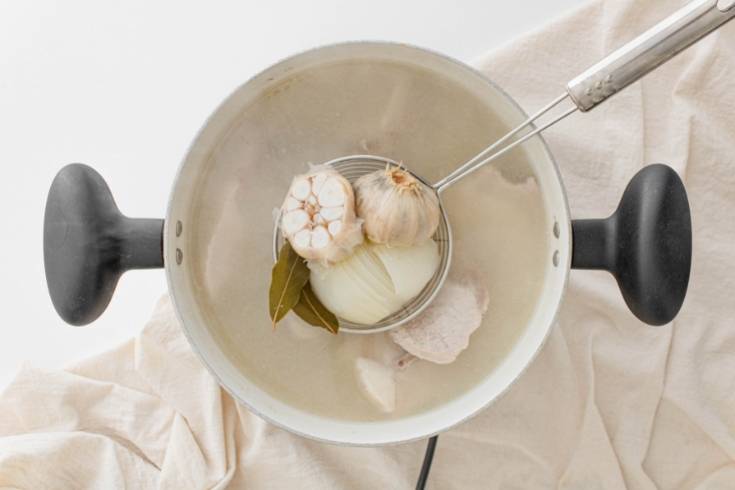 remove whole garlic onion and by leaves from the pot of traditional pozole