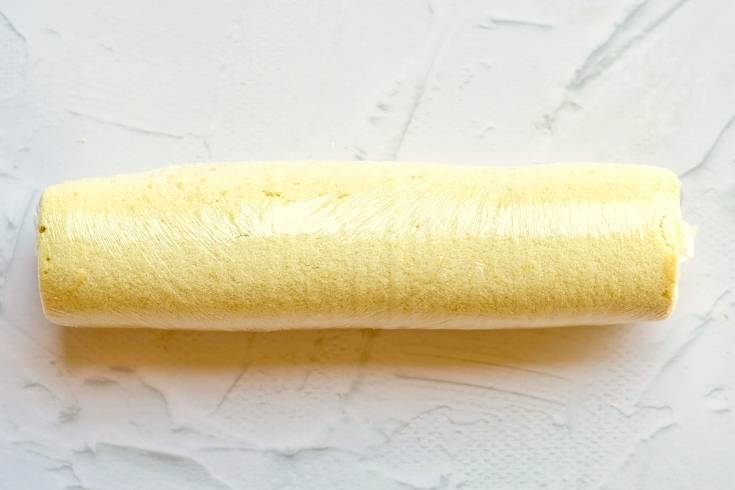 roll buche de noel cake into a log