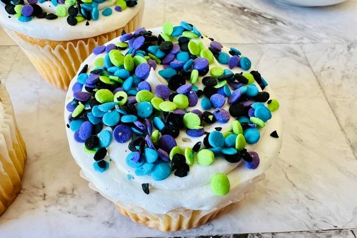 add Halloween sprinkles to frosted cupcakes