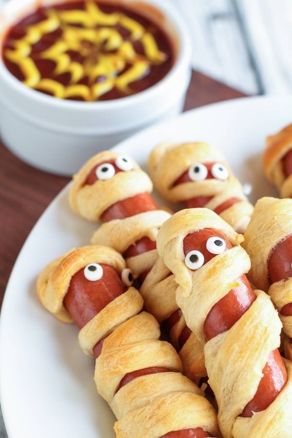 decorate mummy dogs with candy eyes