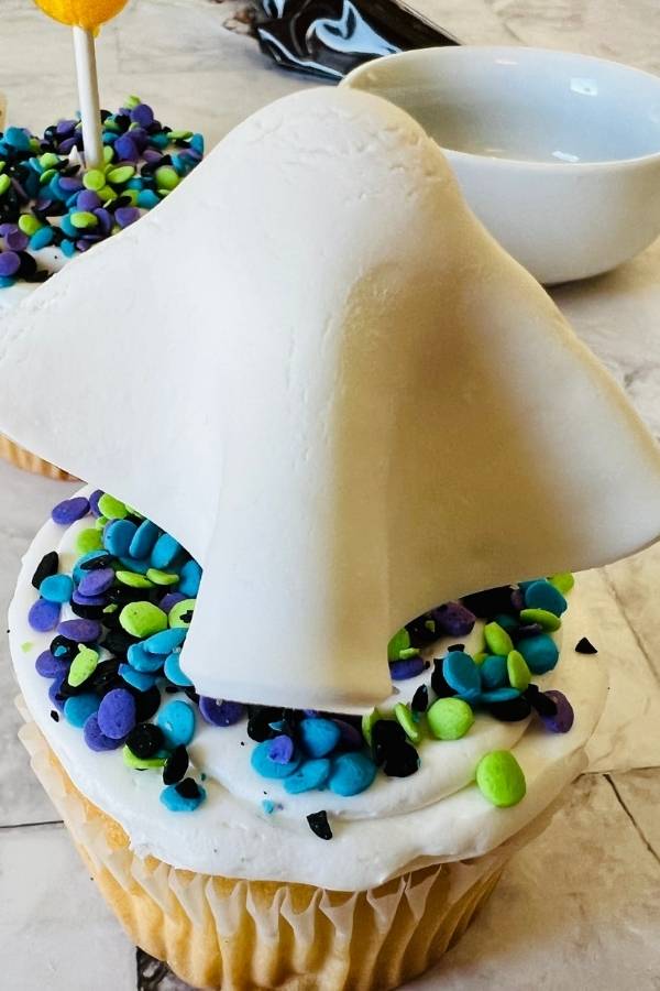 place fondant over lollipop to create ghost cupcake topper