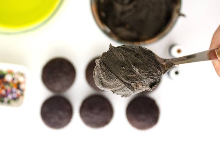 tint the cupcake frosting black using gel food coloring